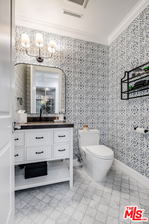 14920 Addison Street Sherman Oaks, CA 91403 - Photo 21 of 52 a bathroom with a toilet a sink and a mirror