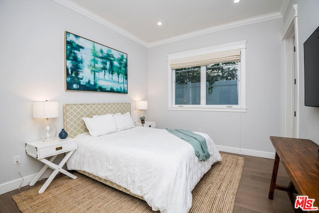 14920 Addison Street Sherman Oaks, CA 91403 - Photo 22 of 52 a bedroom with a bed and a window