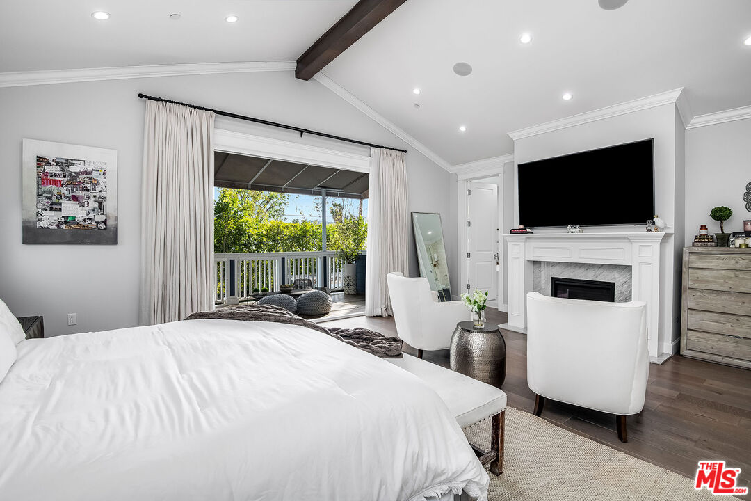 14920 Addison Street Sherman Oaks, CA 91403 - Photo 26 of 52 a bedroom with a large bed and a flat screen tv
