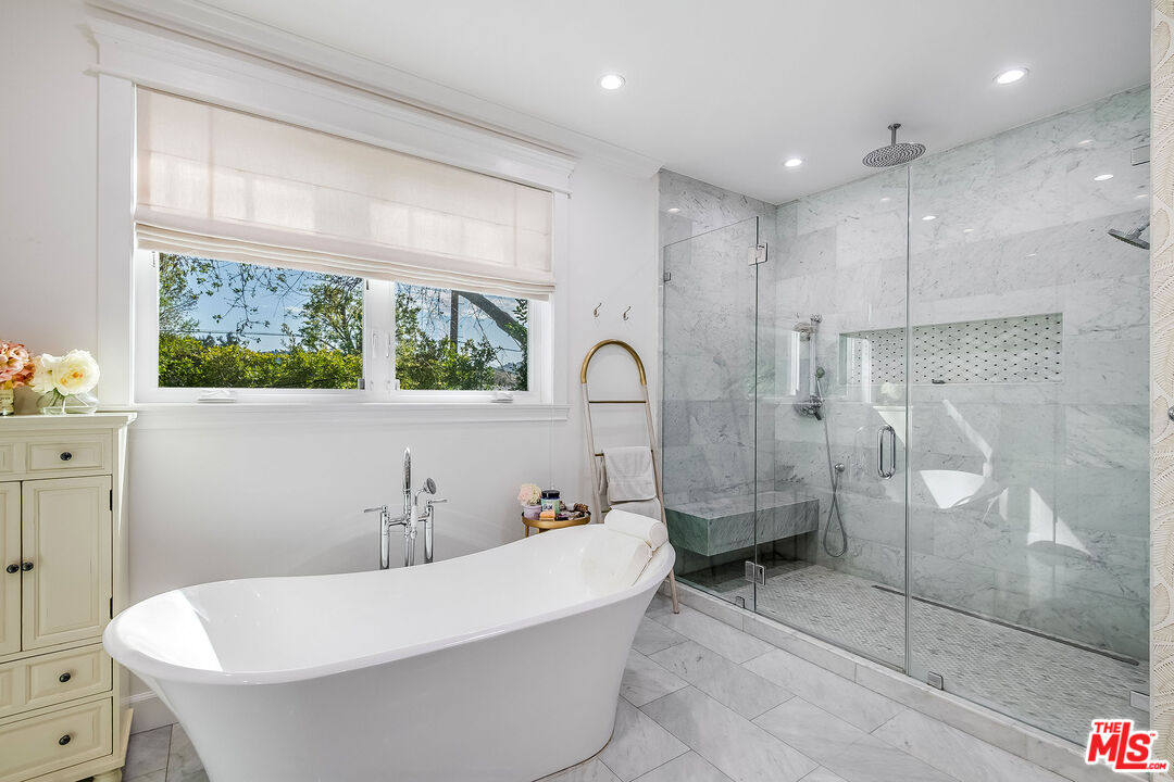 14920 Addison Street Sherman Oaks, CA 91403 - Photo 29 of 52 a white bath tub sitting next to a bathroom sink