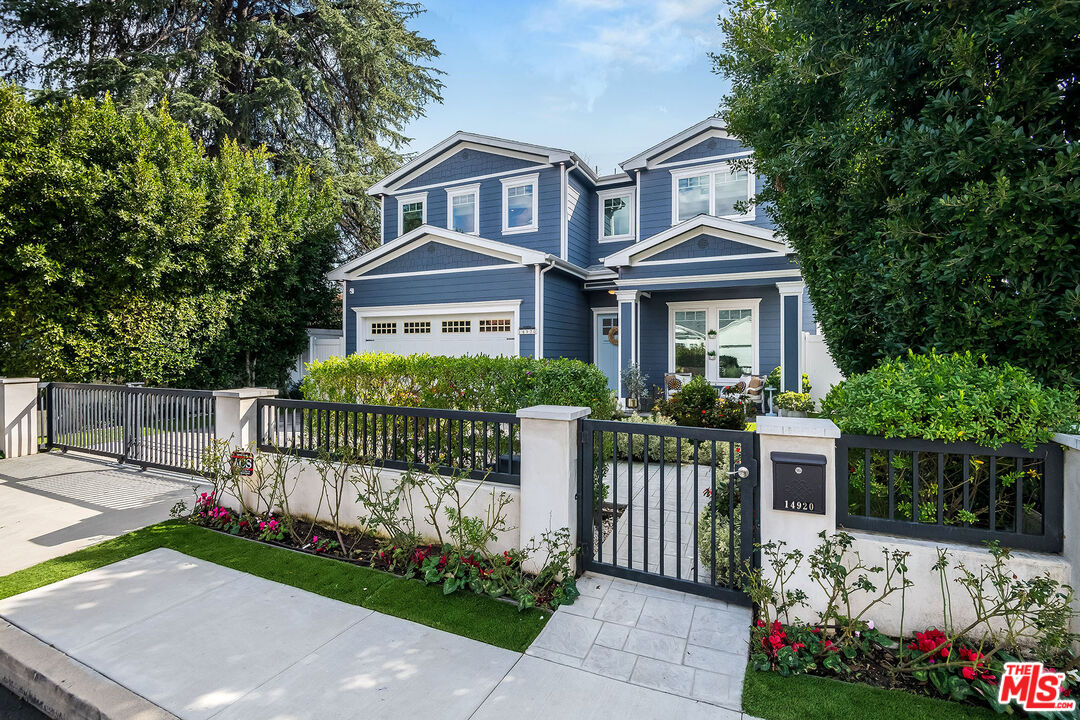 14920 Addison Street Sherman Oaks, CA 91403 - Photo 3 of 52 a front view of a house with a garden