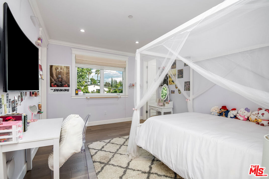 14920 Addison Street Sherman Oaks, CA 91403 - Photo 33 of 52 a bedroom with a bed and a flat screen tv