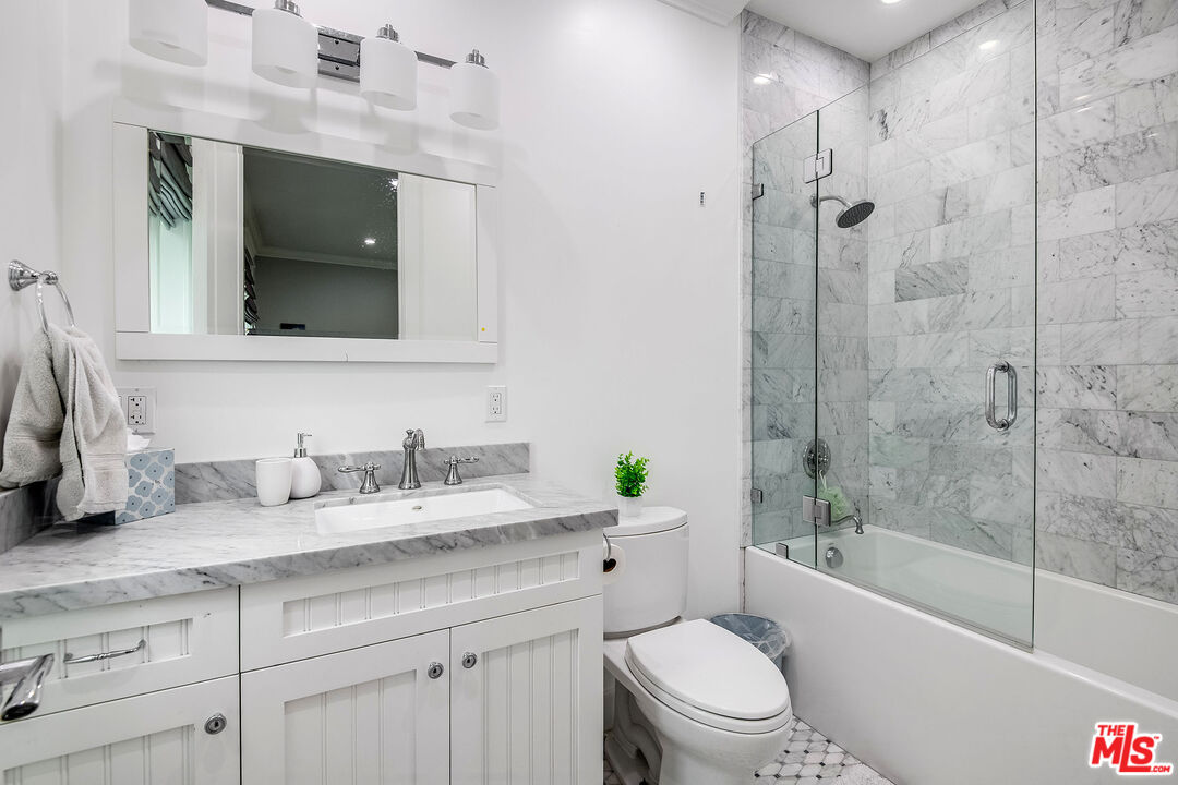 14920 Addison Street Sherman Oaks, CA 91403 - Photo 36 of 52 a bathroom with a granite countertop sink toilet and shower