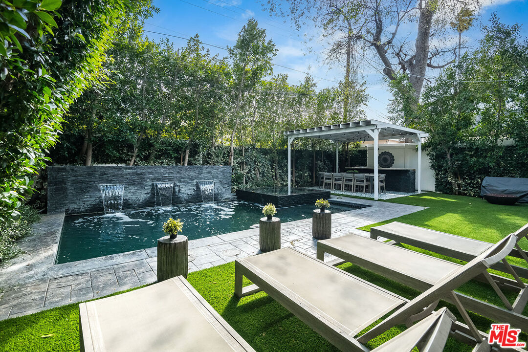 14920 Addison Street Sherman Oaks, CA 91403 - Photo 46 of 52 a view of a patio with couches table and chairs with wooden fence and plants