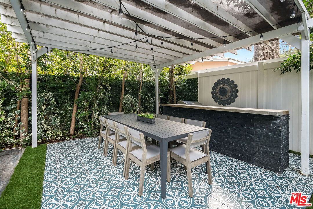 14920 Addison Street Sherman Oaks, CA 91403 - Photo 47 of 52 a table and chairs in a patio