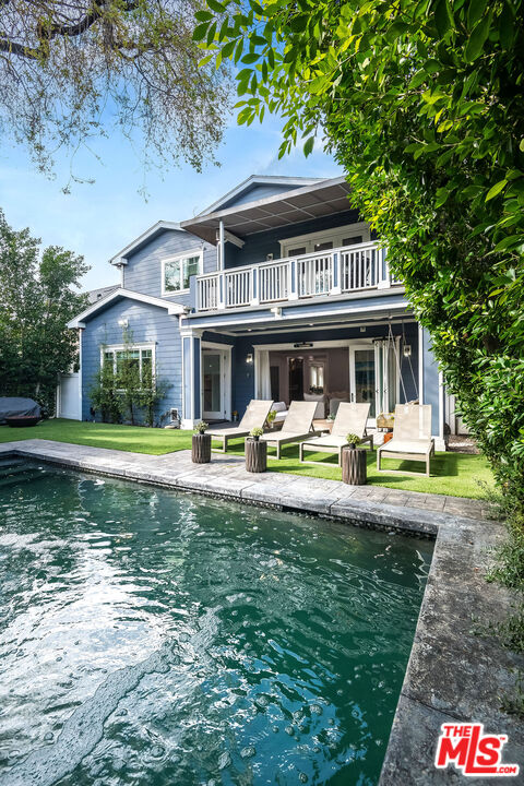 14920 Addison Street Sherman Oaks, CA 91403 - Photo 50 of 52 a front view of a house with swimming pool having outdoor seating
