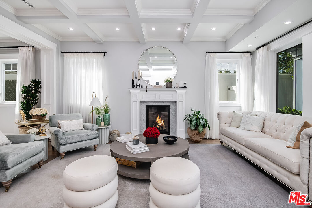 14920 Addison Street Sherman Oaks, CA 91403 - Photo 7 of 52 a living room with furniture a fireplace and a chandelier
