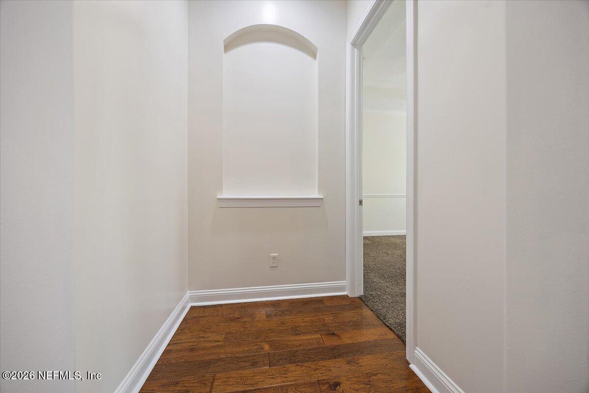 436 Chattan Way Fruit Cove, FL 32259 - Photo 11 of 41 a view of an empty room with wooden floor and a window