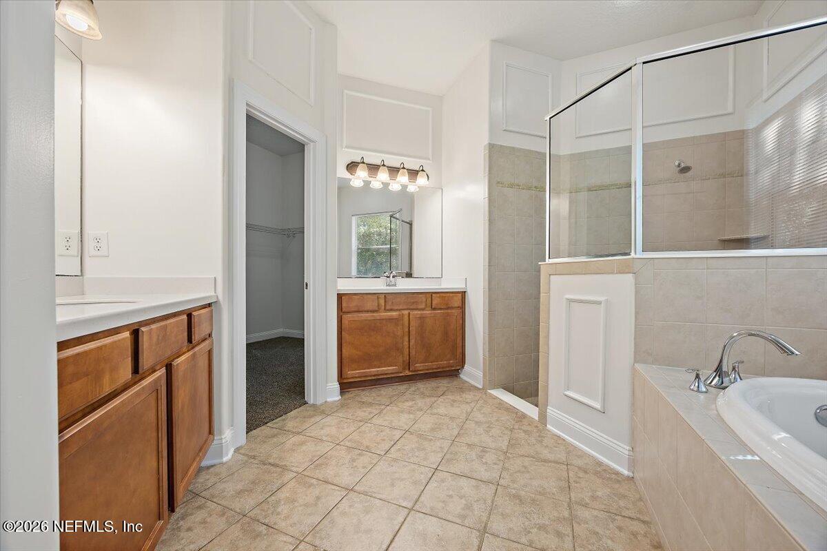 436 Chattan Way Fruit Cove, FL 32259 - Photo 14 of 41 a bathroom with a tub sink and mirror