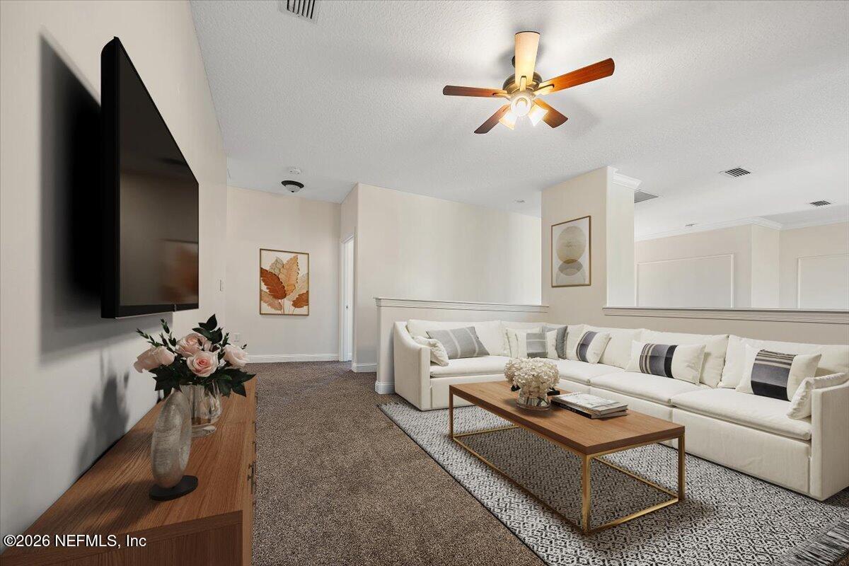436 Chattan Way Fruit Cove, FL 32259 - Photo 19 of 41 a living room with furniture and a flat screen tv