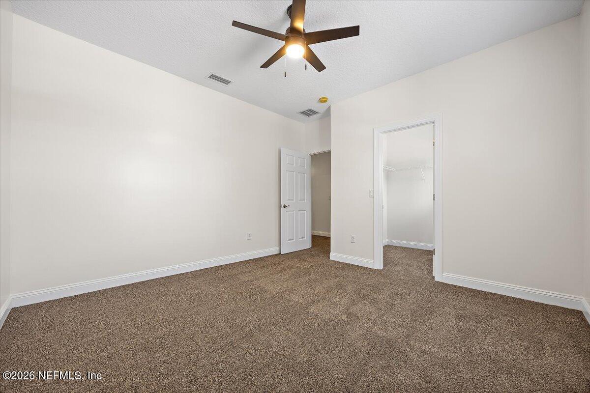 436 Chattan Way Fruit Cove, FL 32259 - Photo 28 of 41 a view of a room with a ceiling fan and carpet