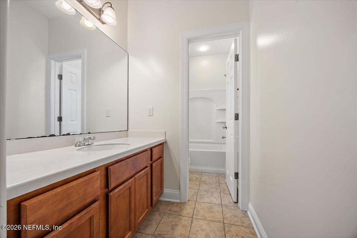 436 Chattan Way Fruit Cove, FL 32259 - Photo 29 of 41 a bathroom with a granite countertop sink and a mirror