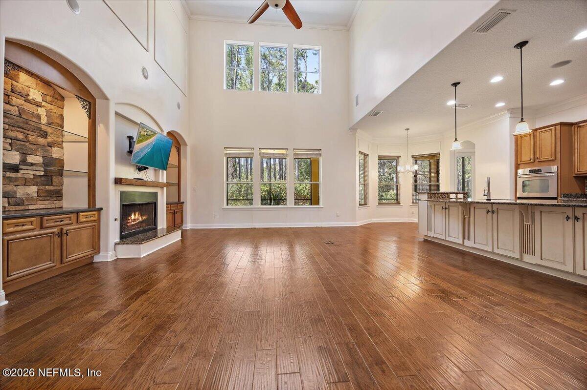 436 Chattan Way Fruit Cove, FL 32259 - Photo 8 of 41 a view of a living room kitchen with furniture and a fireplace
