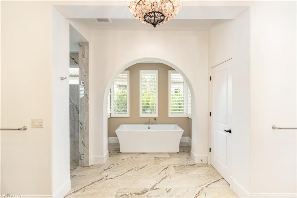 16727 Lucarno Way Naples, FL 34110 - Photo 13 of 48 a bathroom with a sink and a mirror