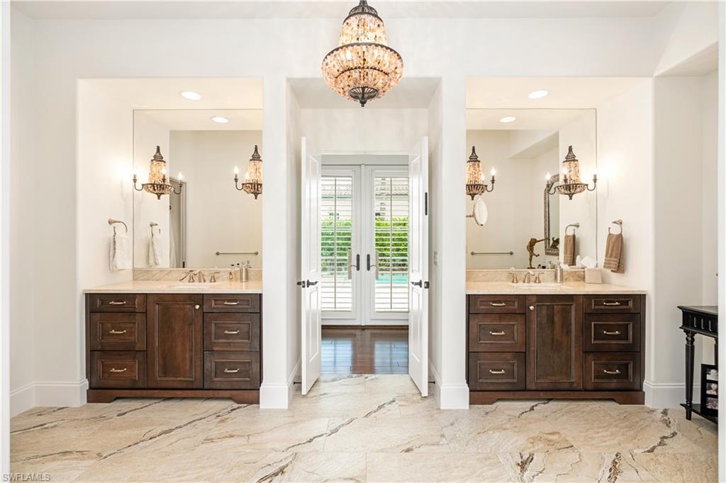 16727 Lucarno Way Naples, FL 34110 - Photo 15 of 36 a view of a bathroom with a sink and a mirror