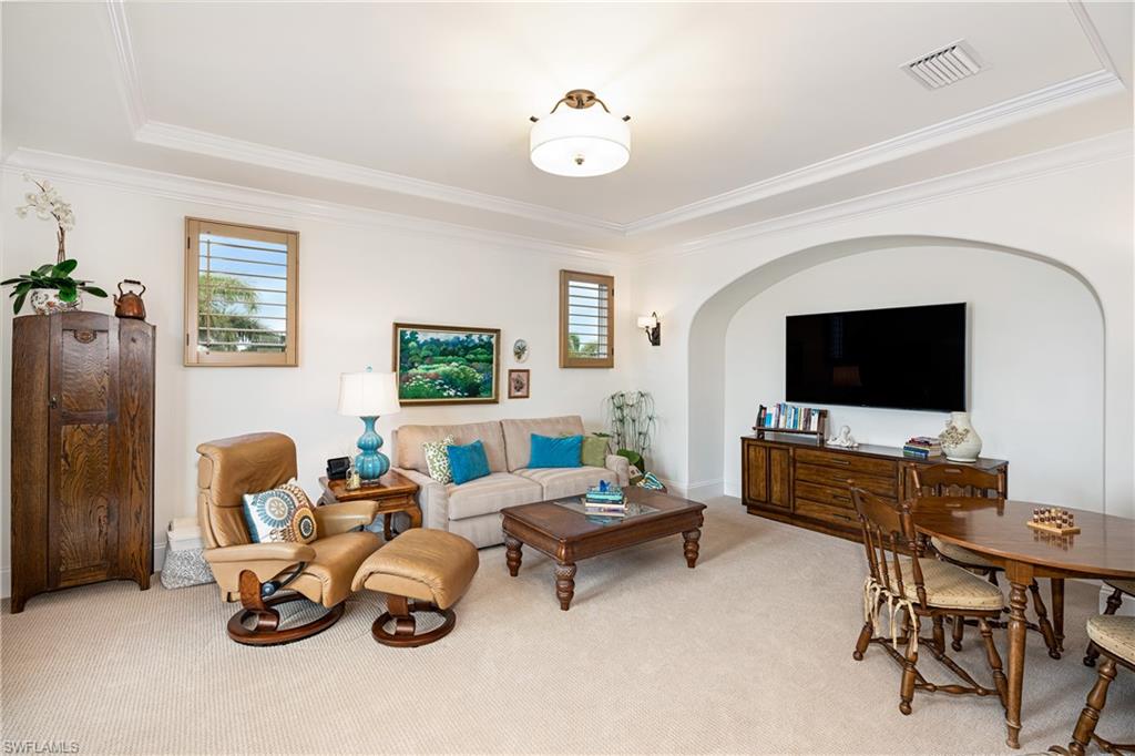 16727 Lucarno Way Naples, FL 34110 - Photo 23 of 36 a living room with furniture and a flat screen tv