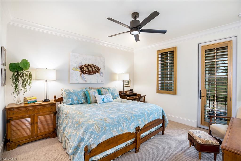 16727 Lucarno Way Naples, FL 34110 - Photo 25 of 36 a bedroom with a bed a dresser and a potted plant