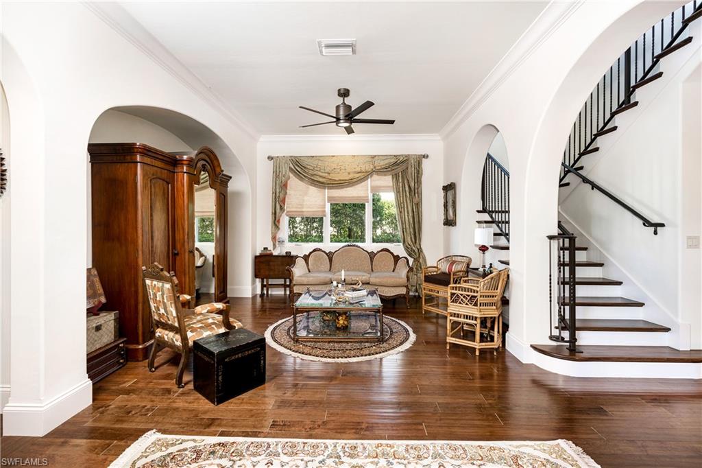 16727 Lucarno Way Naples, FL 34110 - Photo 25 of 48 a living room with couches a dining table and chairs with outer view