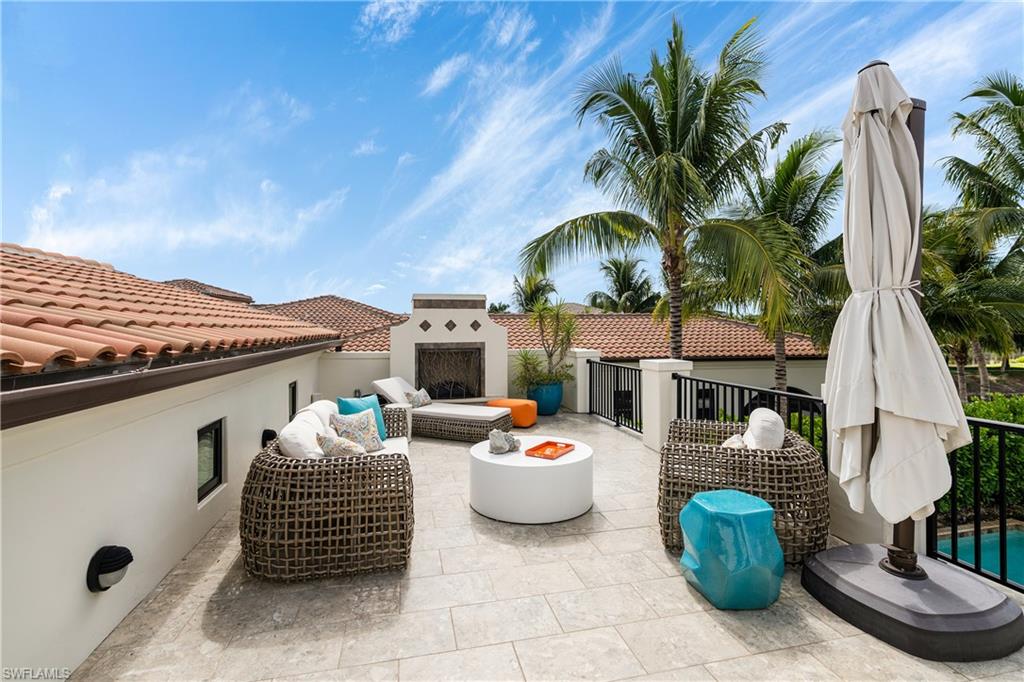 16727 Lucarno Way Naples, FL 34110 - Photo 27 of 36 a table and chairs in front of a house