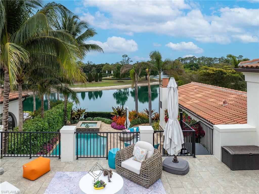 16727 Lucarno Way Naples, FL 34110 - Photo 28 of 36 a view of a patio with a table chairs and a swimming pool