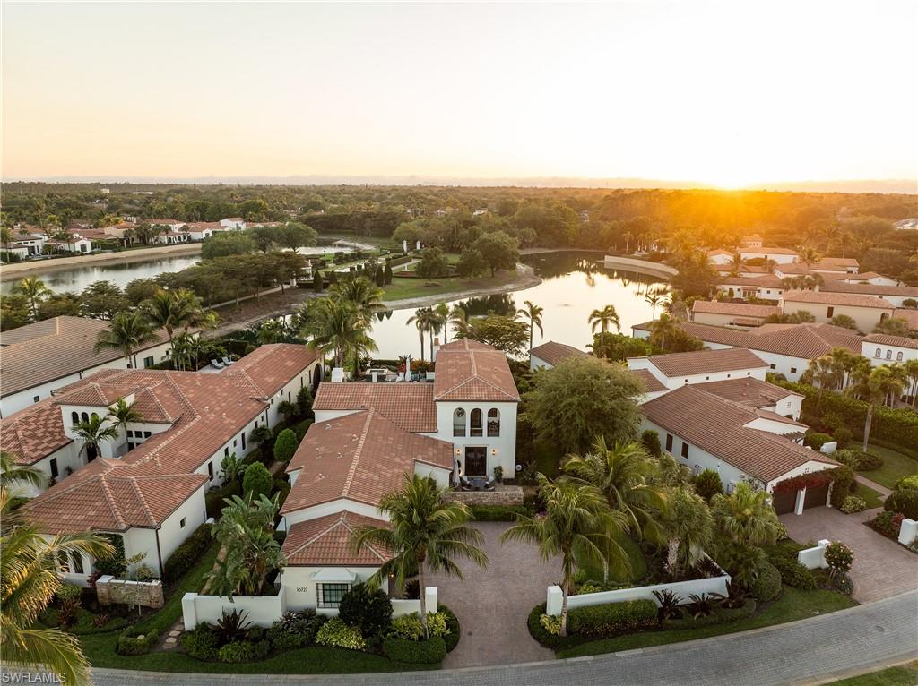 16727 Lucarno Way Naples, FL 34110 - Photo 3 of 48 Aerial view at dusk with a water view and a residential view