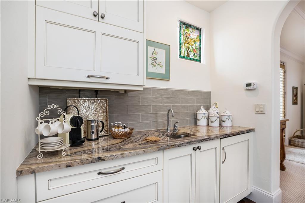 16727 Lucarno Way Naples, FL 34110 - Photo 36 of 48 a kitchen with granite countertop white cabinets and a sink