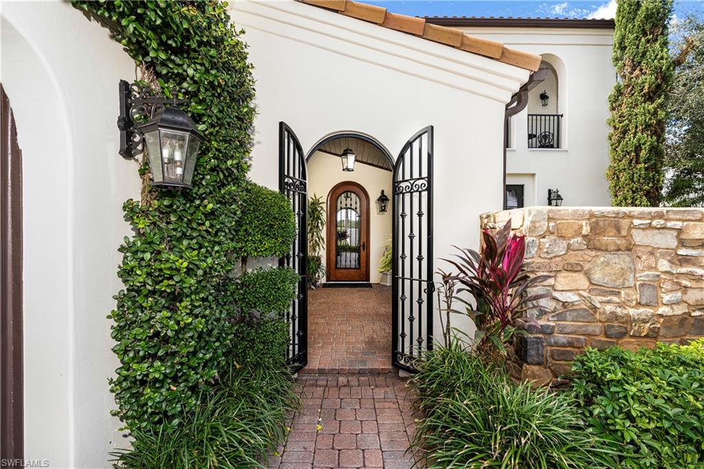 16727 Lucarno Way Naples, FL 34110 - Photo 4 of 48 a front view of a house with garden