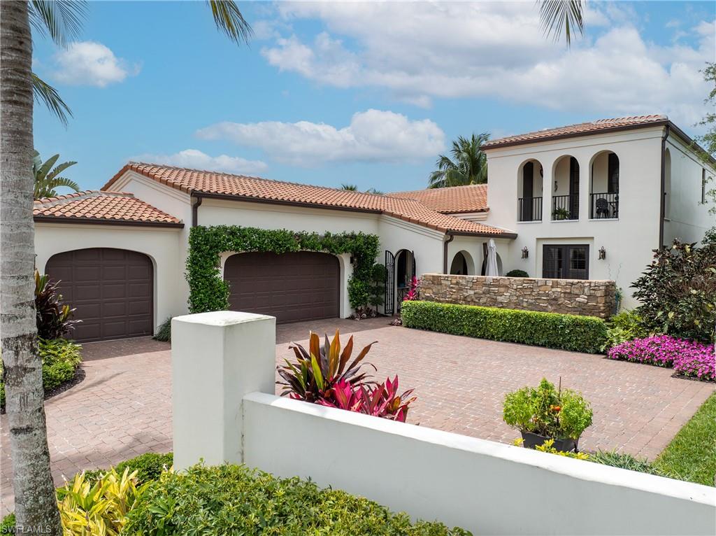 16727 Lucarno Way Naples, FL 34110 - Photo 6 of 48 a front view of a house with a yard