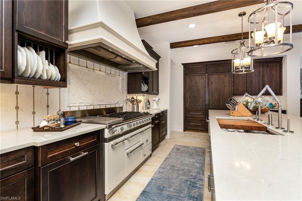16727 Lucarno Way Naples, FL 34110 - Photo 8 of 36 a kitchen with a stove and a refrigerator