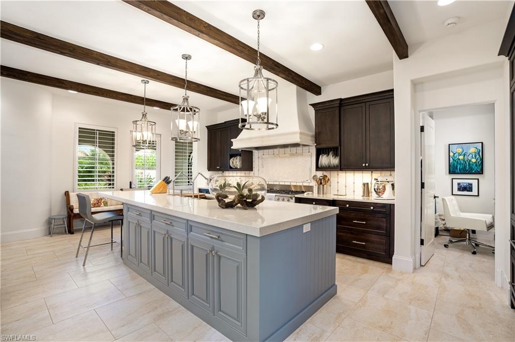 16727 Lucarno Way Naples, FL 34110 - Photo 9 of 36 a kitchen with stainless steel appliances a sink stove and cabinets