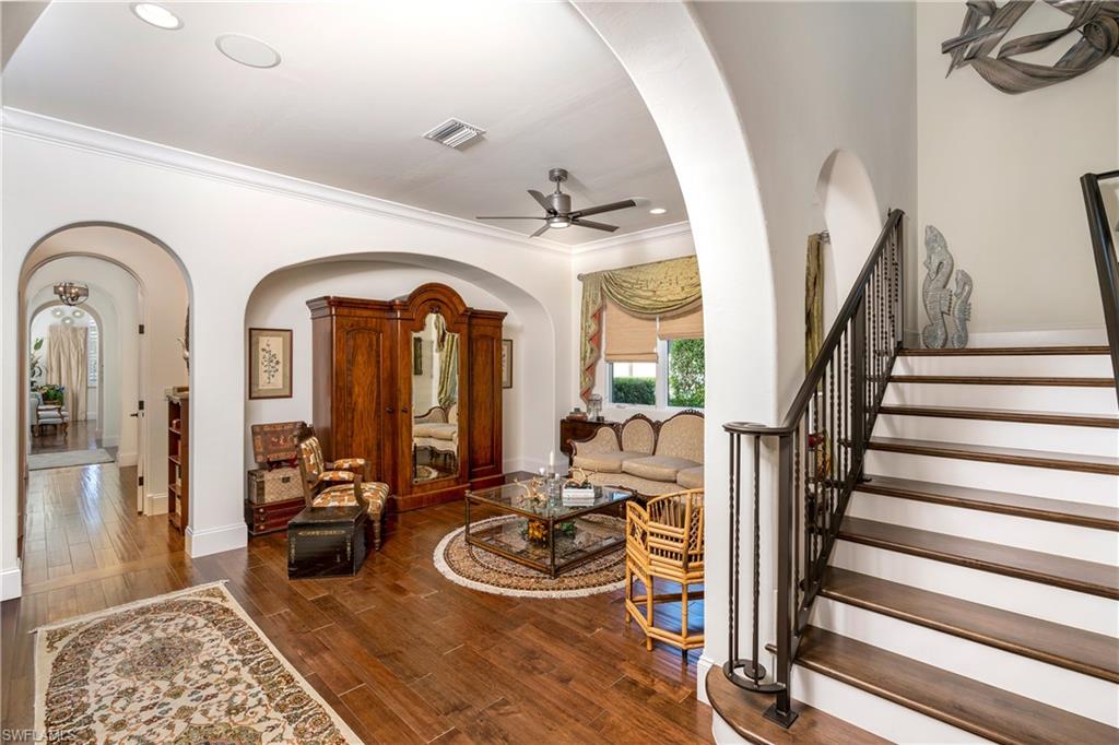 16727 Lucarno Way Naples, FL 34110 - Photo 10 of 36 a view of a livingroom with wooden floor and furniture