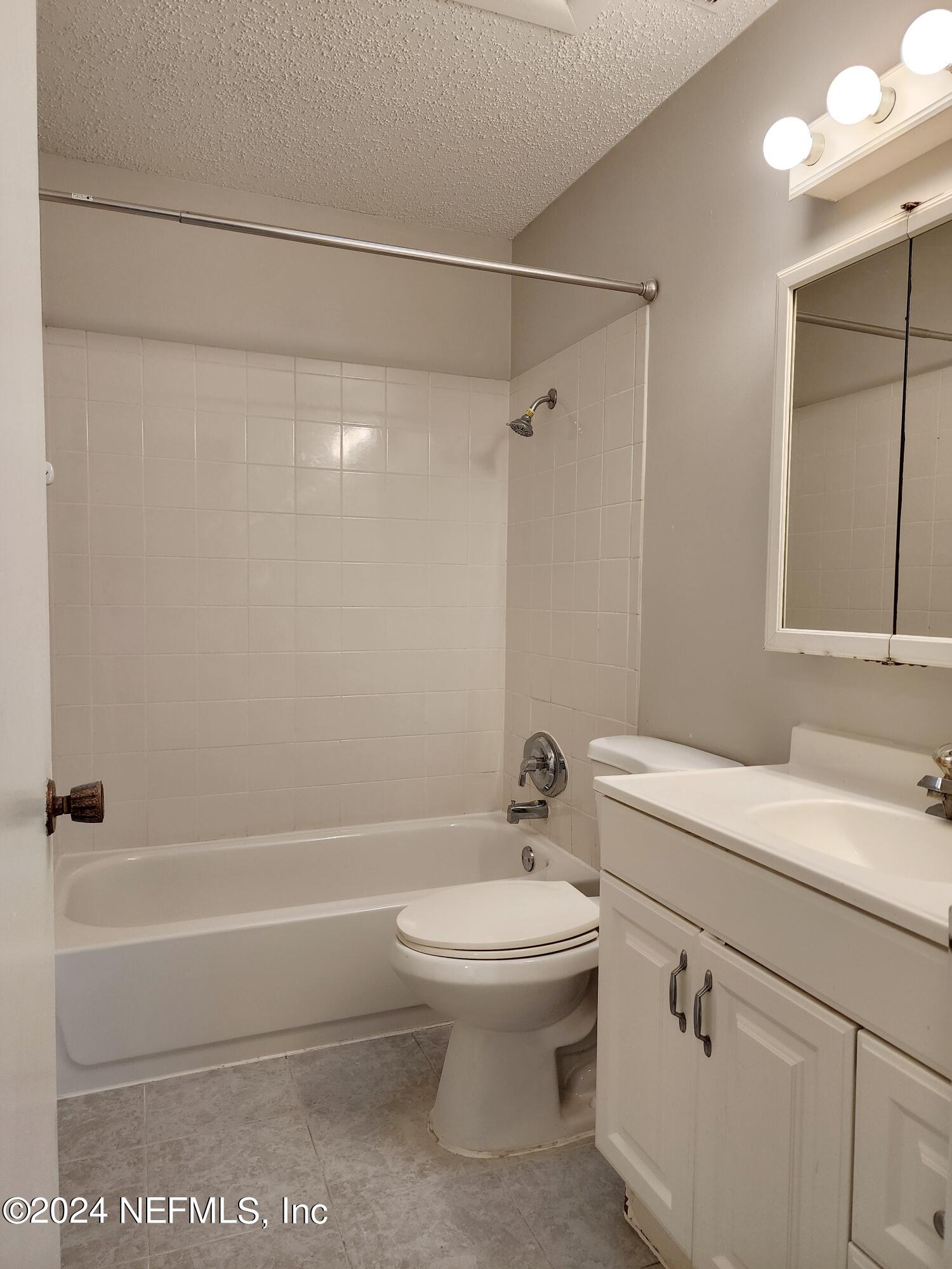 8423 Graybar Drive Jacksonville, FL 32221 - Photo 20 of 29 a bathroom with a sink a toilet and shower