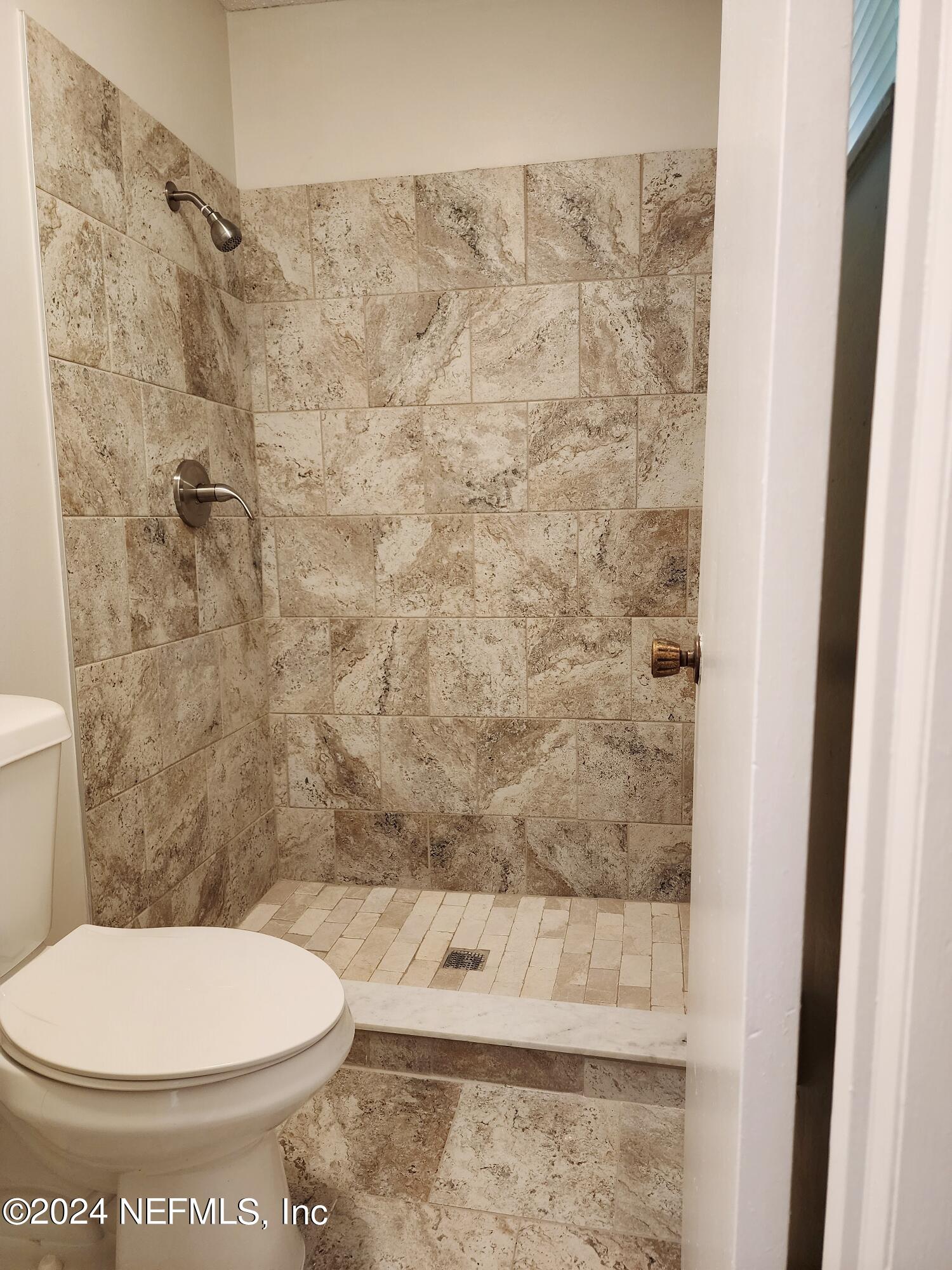 8423 Graybar Drive Jacksonville, FL 32221 - Photo 26 of 29 a bathroom with a toilet and a shower