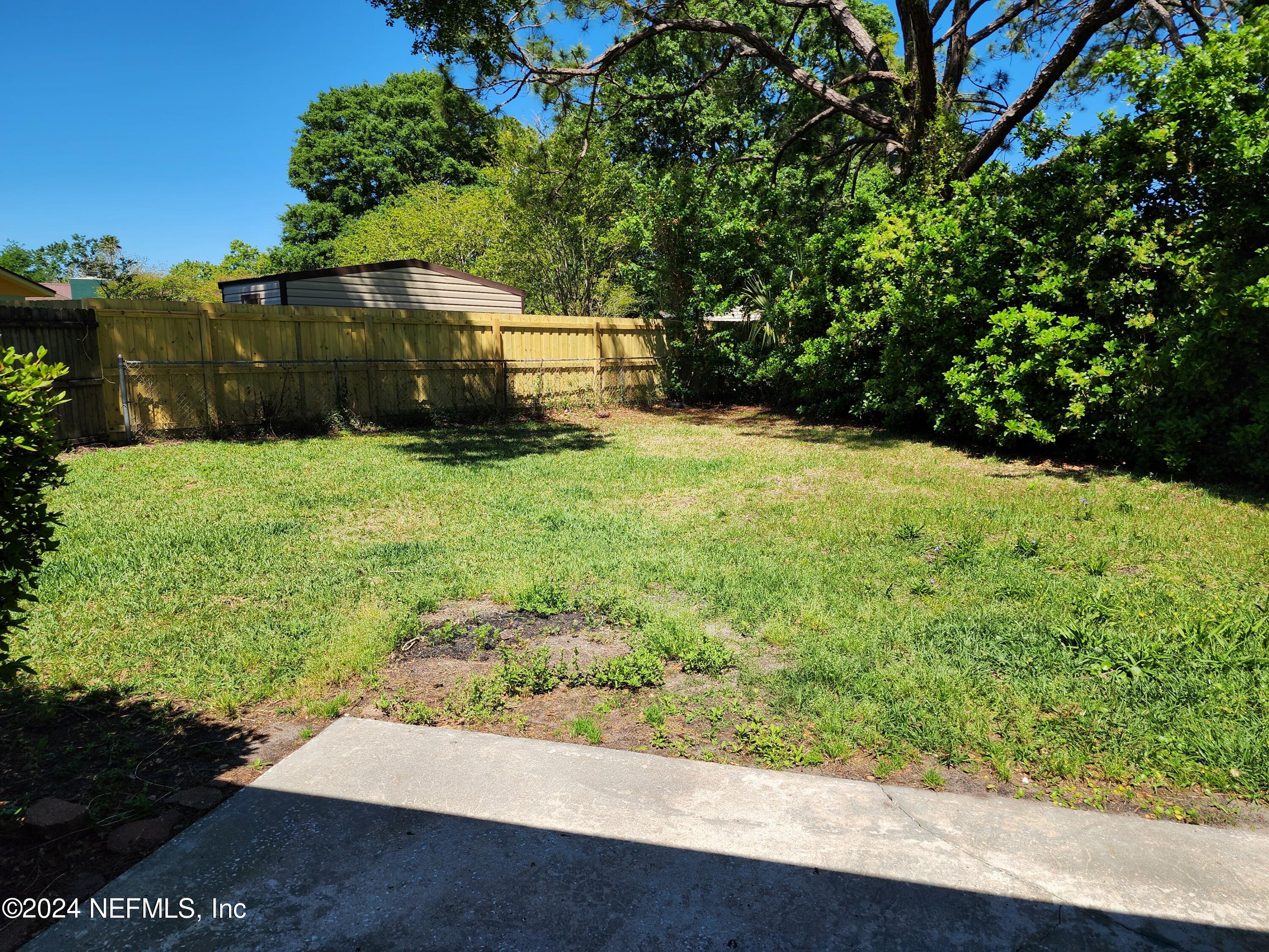 8423 Graybar Drive Jacksonville, FL 32221 - Photo 28 of 29 a backyard of a house with lots of green space