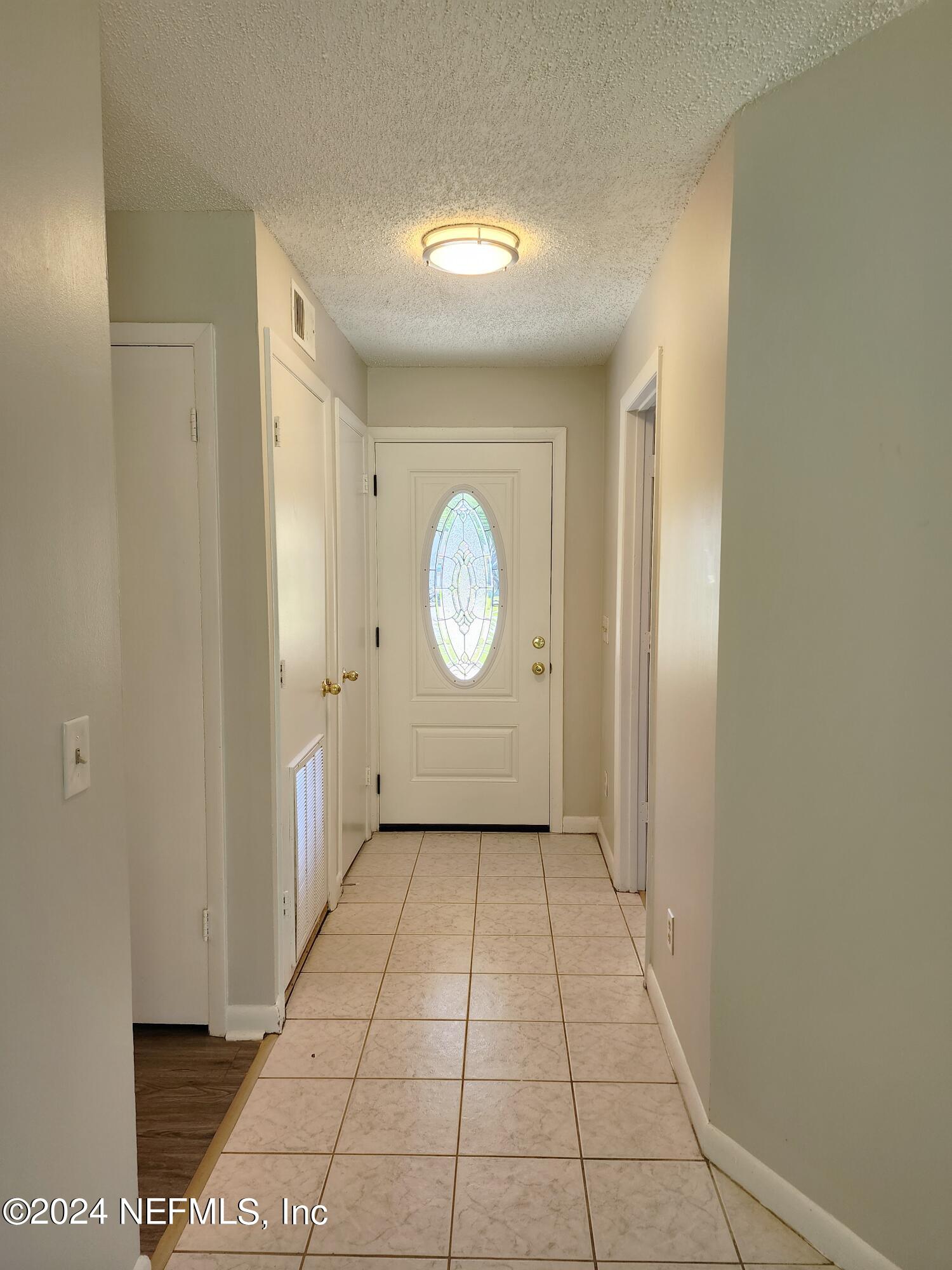 8423 Graybar Drive Jacksonville, FL 32221 - Photo 4 of 29 a view of a hallway with a bathroom