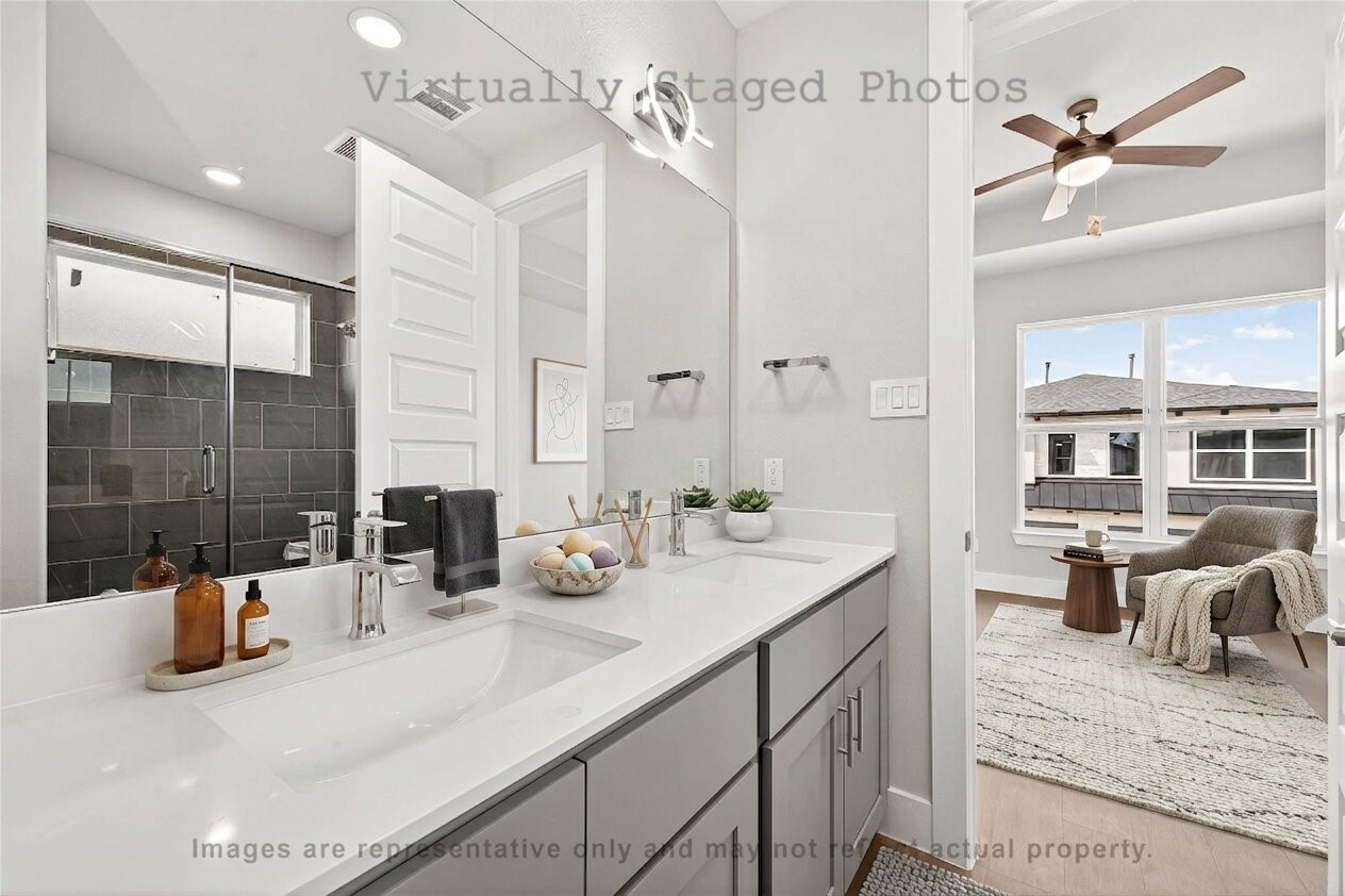 10719 Mason Road, Unit 26 Richmond, TX 77406 - Photo 7 of 50 Virtual Staging - Modern bathroom features a sleek gray double vanity and an open doorway leading to a cozy adjacent seating area