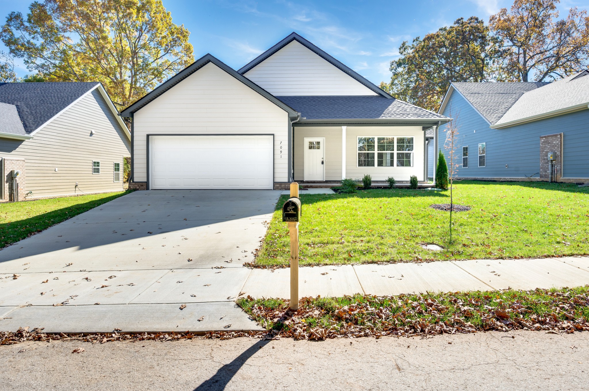 a view of a house with a yard and fence