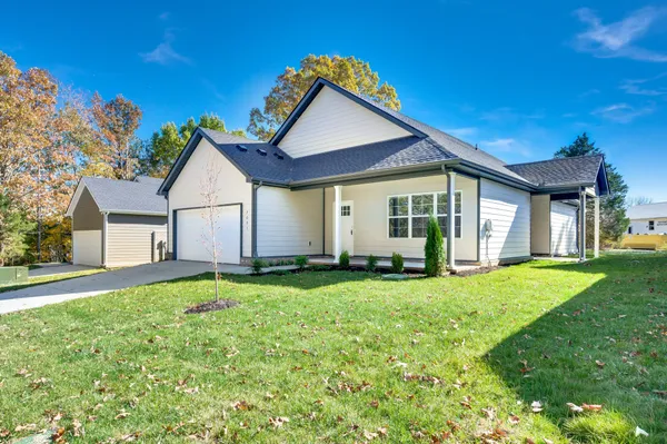 a front view of a house with a yard and garage