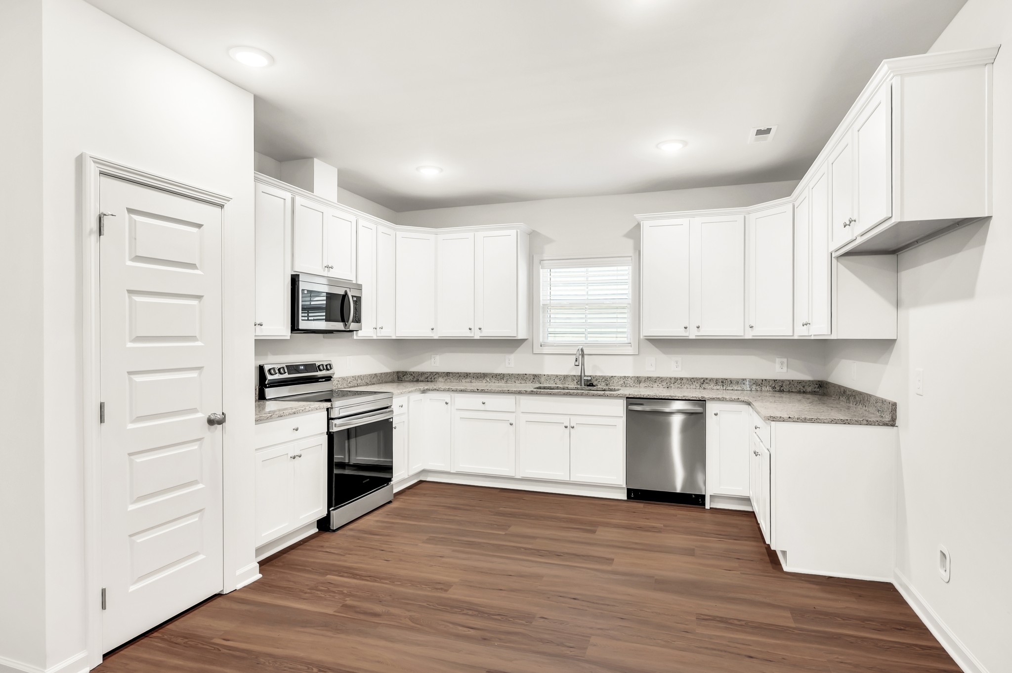 7091 Wiley Circle Fairview, TN 37062 - Photo 11 of 32 a kitchen with granite countertop white cabinets and white appliances