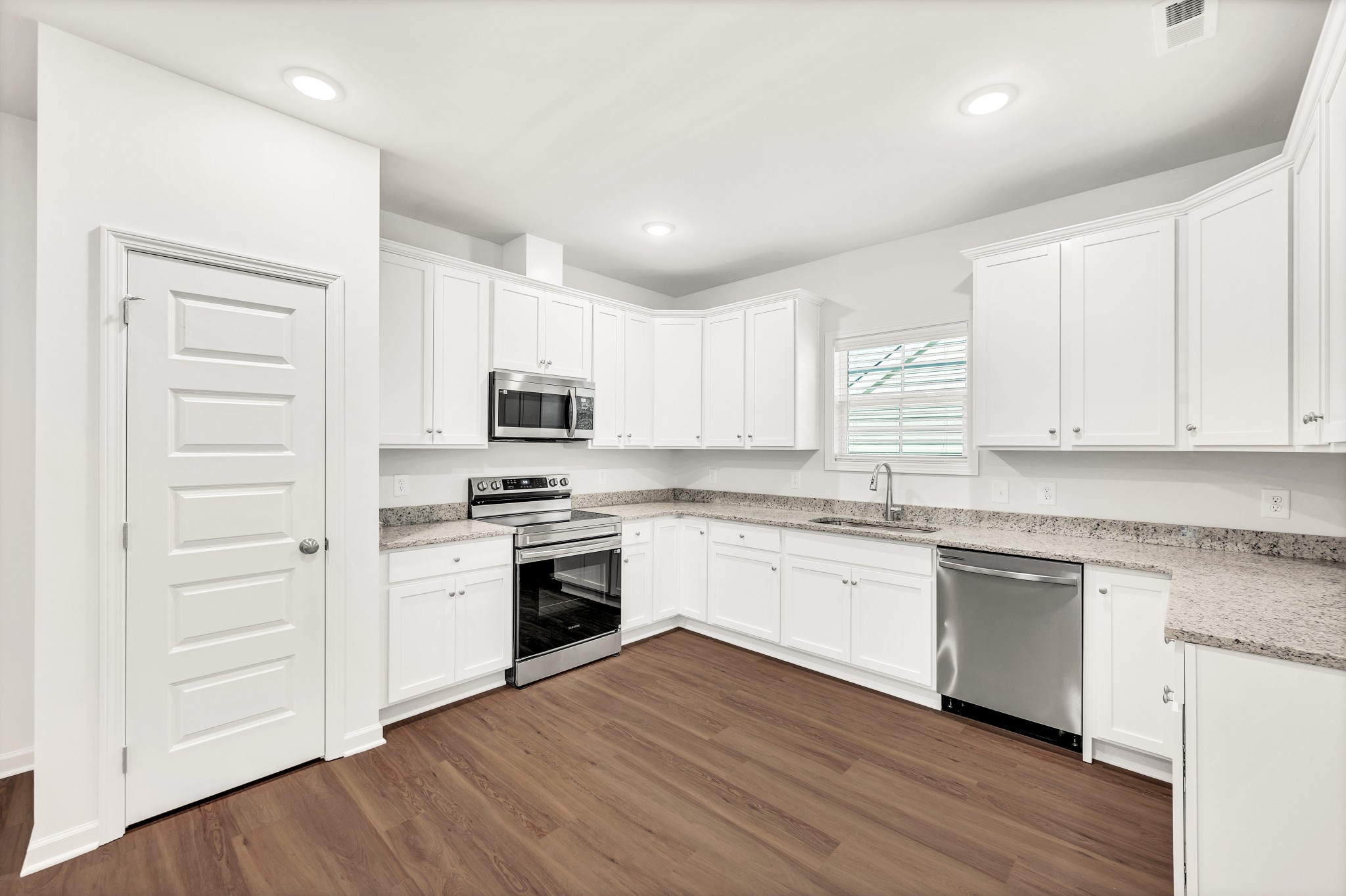 7091 Wiley Circle Fairview, TN 37062 - Photo 13 of 32 a kitchen with granite countertop white cabinets and white appliances
