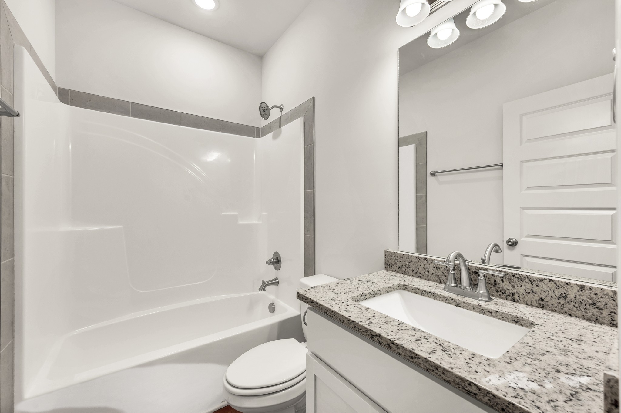 7091 Wiley Circle Fairview, TN 37062 - Photo 19 of 32 a bathroom with a granite countertop sink mirror toilet and bathtub