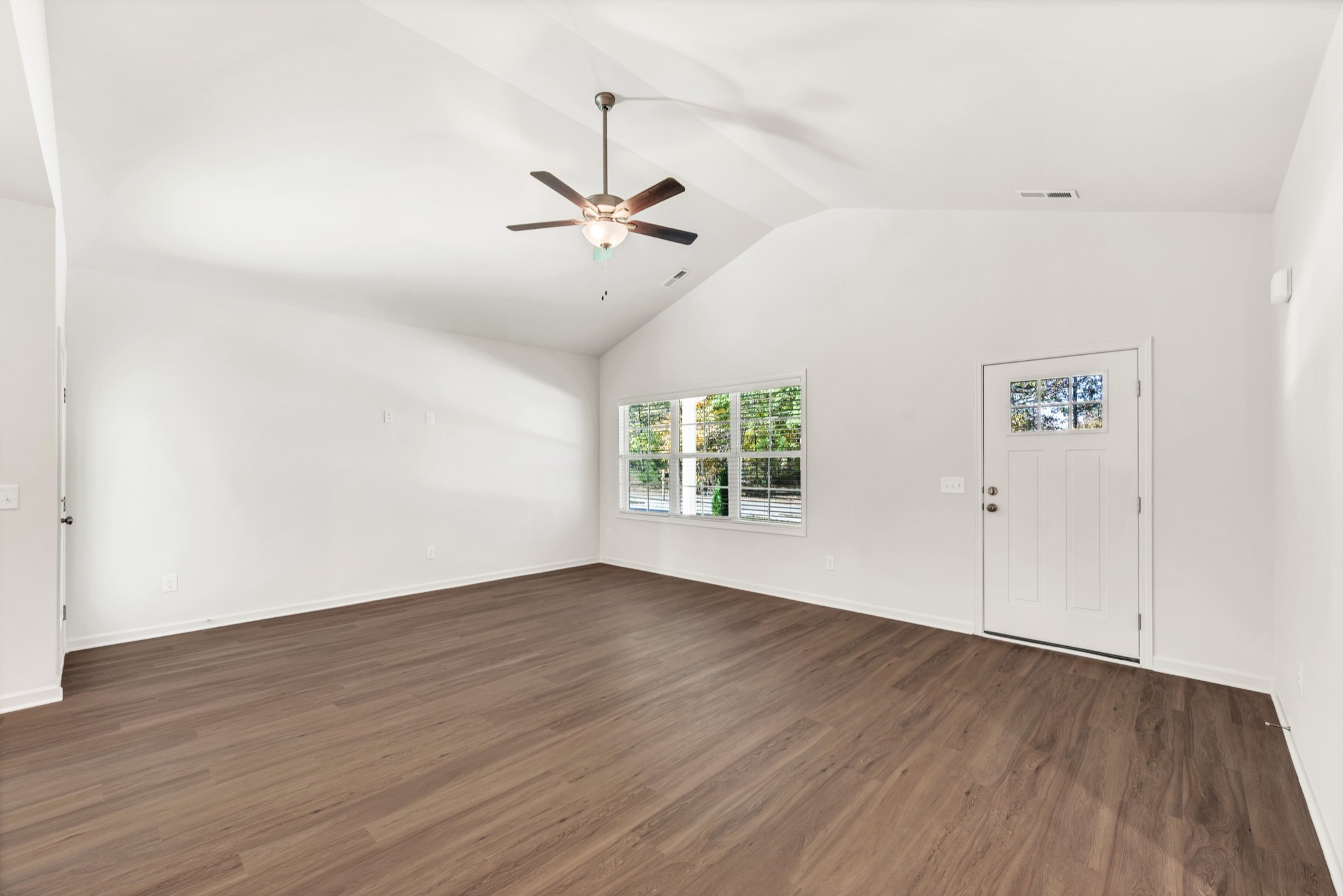 7091 Wiley Circle Fairview, TN 37062 - Photo 6 of 32 an empty room with wooden floor chandelier fan and windows