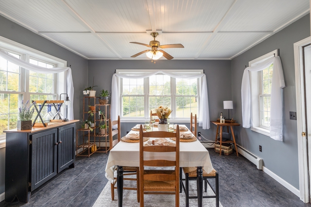 2 South County Road Leyden, MA 01301 - Photo 3 of 42 a dining room with wooden floor a chandelier a flat screen tv and a large window