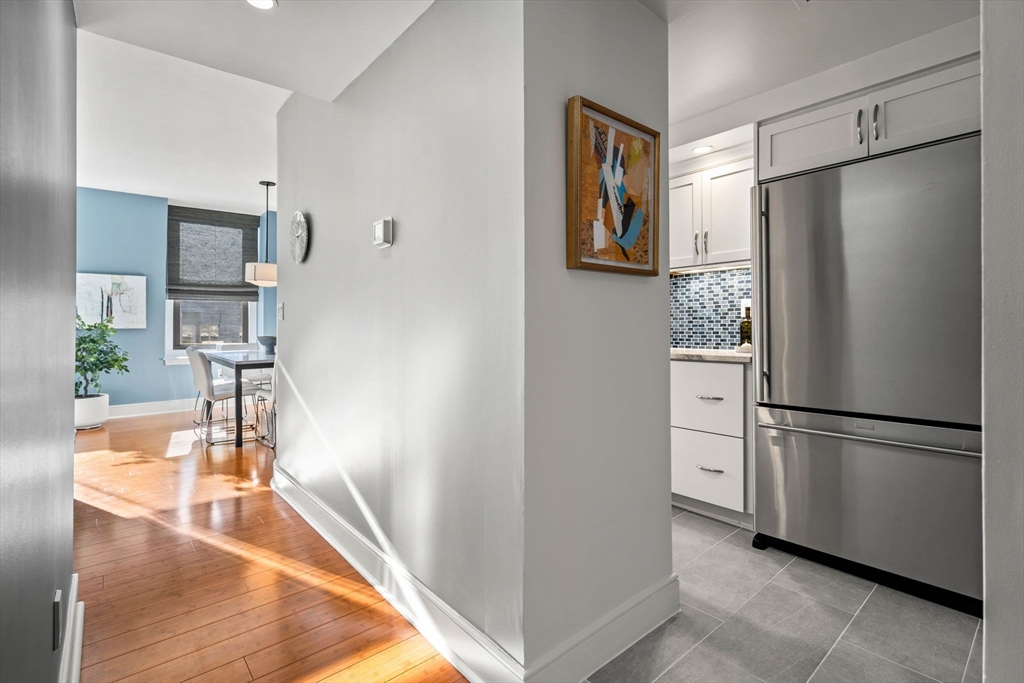 201 Newbury Street, Unit 405 Boston, MA 02116 - Photo 11 of 17 a kitchen with stainless steel appliances granite countertop a refrigerator and a stove top oven