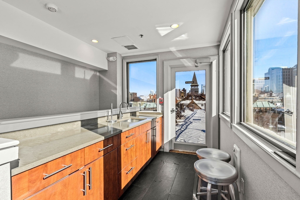 201 Newbury Street, Unit 405 Boston, MA 02116 - Photo 14 of 17 a kitchen with a table and chairs