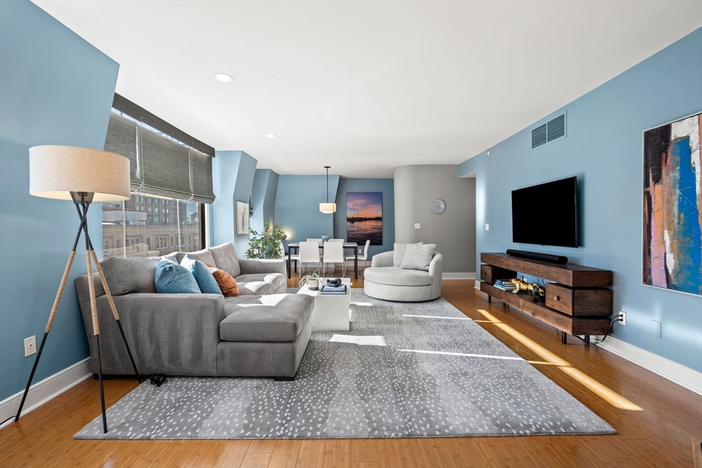 201 Newbury Street, Unit 405 Boston, MA 02116 - Photo 2 of 17 a living room with furniture and a flat screen tv