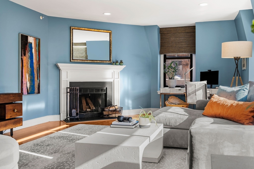 201 Newbury Street, Unit 405 Boston, MA 02116 - Photo 3 of 17 a living room with furniture and a fireplace