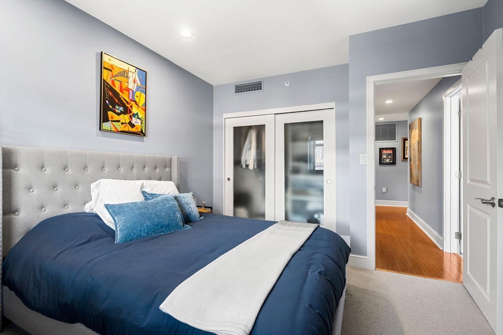 201 Newbury Street, Unit 405 Boston, MA 02116 - Photo 10 of 17 a bedroom with a bed and painting on the wall
