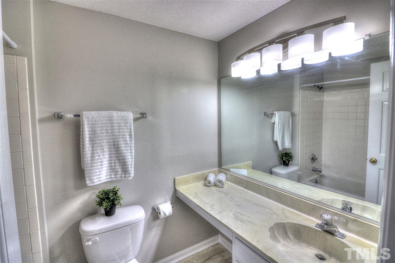 1909 Summerlyn Court Raleigh, NC 27609 - Photo 14 of 24 a bathroom with a granite countertop sink and a mirror