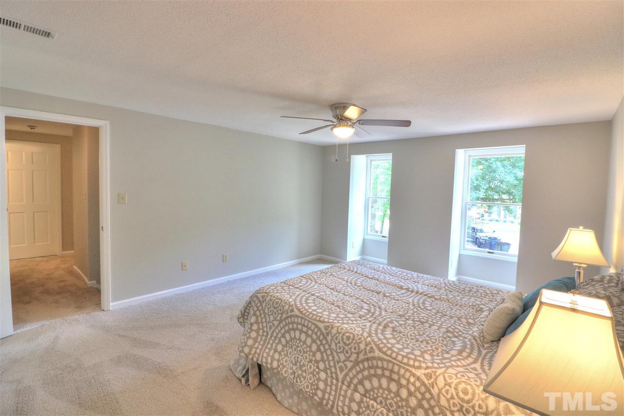 1909 Summerlyn Court Raleigh, NC 27609 - Photo 15 of 24 a bedroom with a bed and a chandelier